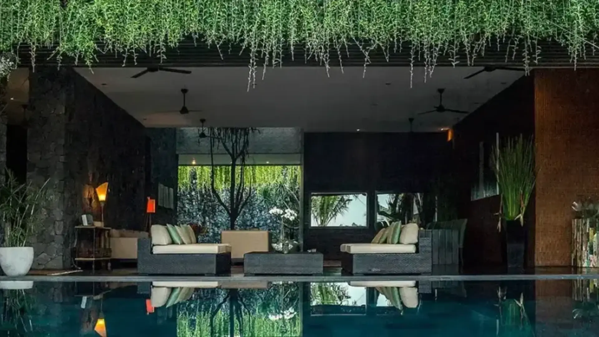 Dark timber and water in a contemporary Bali villa