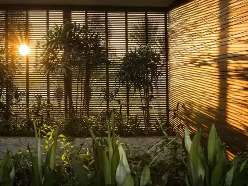 Timber screen lit at night in Bali
